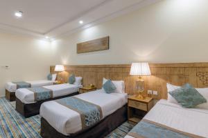 Ένα ή περισσότερα κρεβάτια σε δωμάτιο στο Snood Al Dana Hotel