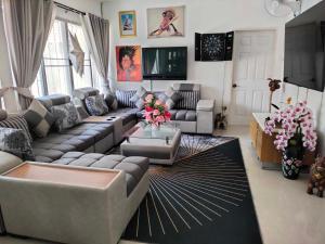 a living room with a couch and a table at Phala Sunshine Villa in Ban Phala