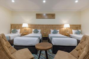 Ένα ή περισσότερα κρεβάτια σε δωμάτιο στο Snood Al Dana Hotel