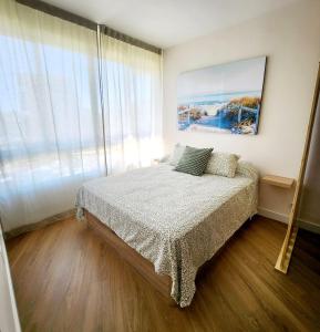 a bedroom with a bed and a large window at Estudio MELMAR en Playamar in Torremolinos