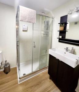 a bathroom with a glass shower and a sink at Estudio MELMAR en Playamar in Torremolinos