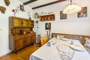 a dining room with a table with a white table cloth at Ferienwohnung Regina in Furtwangen +20 photos