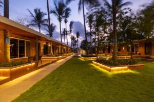 a courtyard with palm trees and a building at Coco Bliss By Mauli Stays in Manor
