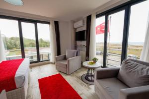 a room with a bed and a couch and a table at Yalıköy Deniz Otel Istanbul in Yalıköy