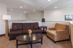 a living room with a couch and two chairs and a table at Baymont by Wyndham Barstow Historic Route 66 in Barstow