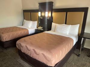 a hotel room with two beds and a phone at Quality Inn Dalton Central in Dalton +16 photos