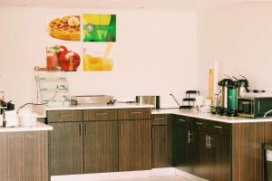 a kitchen with wooden cabinets and a microwave at Quality Inn near Chattanooga South in Ringgold