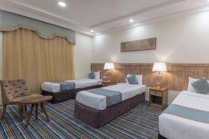 Ένα ή περισσότερα κρεβάτια σε δωμάτιο στο Snood Al Dana Hotel