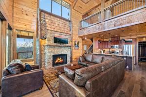 a living room with leather furniture and a fireplace at Ace In The Hole in Sevierville