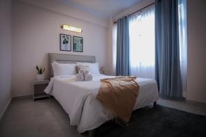 a bedroom with a bed with two teddy bears on it at Griha Units in Kathmandu