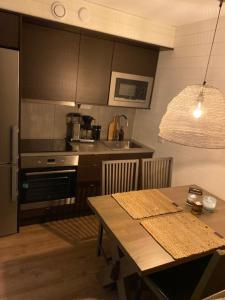 a kitchen with a table and a kitchen with a stove at Sälfjällstorget in Sälen