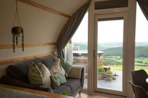 a living room with a couch and a sliding glass door at Aberystwyth by Wigwam Holidays in Aberystwyth