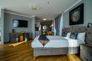 a bedroom with a large bed and a couch at Boardinghouse City Home - Living in Bielefeld