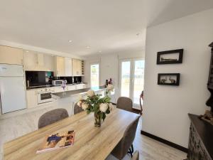 a kitchen with a wooden table with a vase of flowers at Penthouse Sabina in Torrevieja