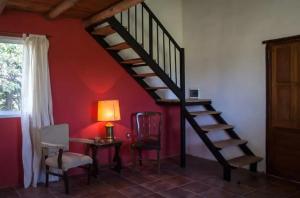 a room with a staircase and a table and a lamp at Cabañas El Gaucho in Mercedes
