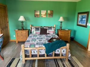 a bedroom with a bed with a green wall at Cabin - Hot tub - Fire pit - View - Getaway! in Oak Harbor