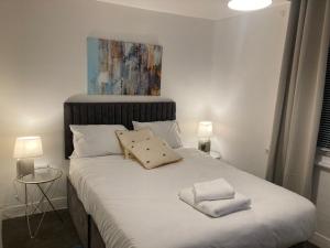 a bedroom with a bed with two towels on it at North Coast Hotel in Blackpool