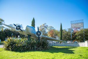 a propeller airplane is sitting in the grass at Kyriad Cannes - Mandelieu in Cannes