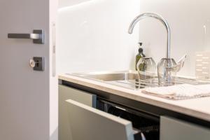 a kitchen with a sink and a counter top at Trubarjeva City apartments in Ljubljana +57 photos