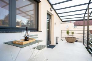 a glass roofed patio with a table and a chair at Trubarjeva City apartments in Ljubljana