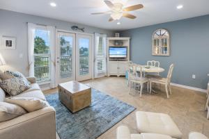 a living room with a couch and a table at Grand Caribbean East 207 By Pkrm in Pensacola
