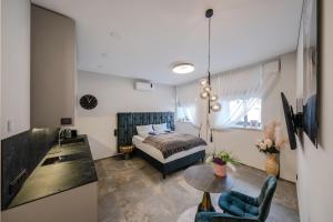 a bedroom with a bed and a table at Old Town - Bajor Studios 2 - Self Check-in and Parking in Kaunas