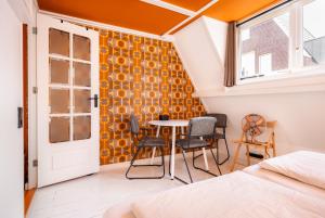 a room with a bed and a table and chairs at The Disco Duck A - city centre Zwolle in Zwolle