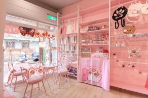 a pink room with a table and chairs at Stars walk slowly in Tainan