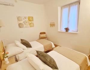 a hospital room with two beds and a window at Casa Bella Locarno in Locarno