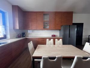 a kitchen with a table and chairs and a refrigerator at Unikatowy Dom 200 m2, Mielno, Pawłowo, Olsztynek in Mielno +14 photos