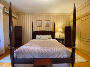 a bedroom with a large bed with a wooden frame at Imperial room in Cairo