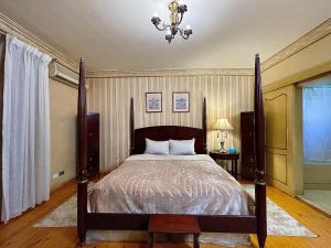 a bedroom with a bed and a chandelier at Imperial room in Cairo