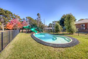 a small pool with a slide in a yard at Ashwood Alpine House in Bright