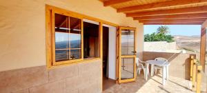 a balcony with windows and a table and chairs at The Black Horse Canarias - Adults Only in Maspalomas