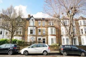three cars parked in front of a large house at S6 Cozy Studio In Kilburn With Kitchen London Zone 2 in London
