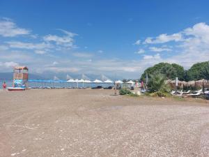 a beach with a bunch of white umbrellas on the water at Villa Iroko in Patra