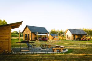 a park with a playground and a cabin at Bobrowa dolinka in Kolonia Horbów