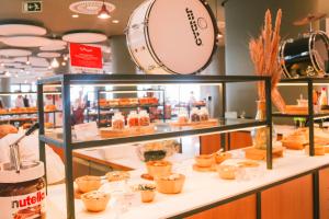 a bakery display case with cakes and pastries at Hard Rock Hotel Ibiza in Playa d'en Bossa