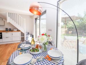 a dining room with a table with a vase of flowers at Hopkins at The Homestead in Dover +35 photos