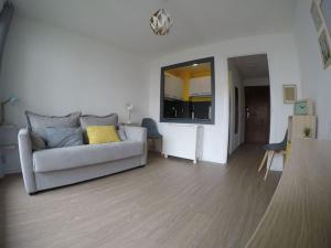 a living room with a couch and a table at Joli studio au centre ville in Aix-les-Bains