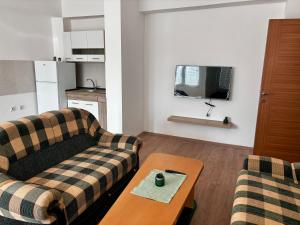 a living room with two couches and a coffee table at Central Comfort- Fresh & Modern in Bitola