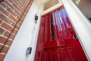 a red door on the side of a brick building at The Disco Duck B - city centre Zwolle in Zwolle