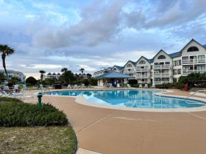 a swimming pool at a resort with condos at Plantation West Condos in Gulf Highlands