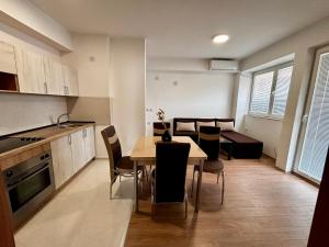a kitchen and dining room with a table and chairs at Central Comfort- Fresh & Modern in Bitola