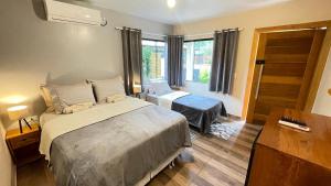 a bedroom with a large bed and a window at Pousada Cair do Sol in Ilha do Mel