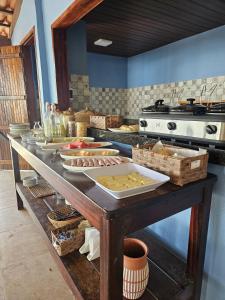 a counter in a kitchen with food on it at Malie Hotel in Águas Belas