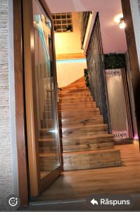 a stairway with a glass door in a house at Muz in Filiaşi