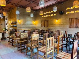 a restaurant with a bunch of chairs in a room at Pousada Maria Bonita Abreu e Lima in Maricota