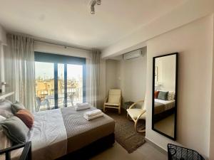 a bedroom with a bed and a mirror and a balcony at Alki-House in Athens