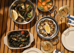 a table with four bowls of food on it at Margot Sololaki in Tbilisi City
